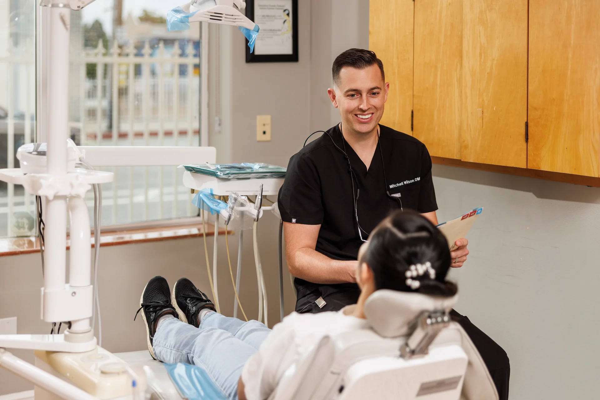 Dr. Wilson speaking with a patient in the dental chair
