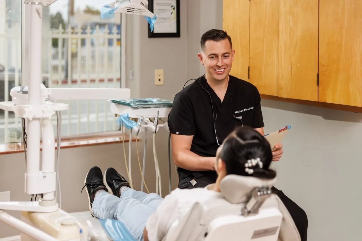 Dr. Wilson chatting with a patient in a treatment room at Paradise Dental Group